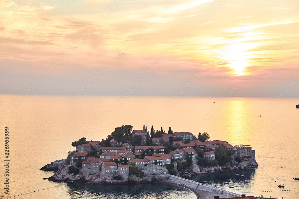 The island of Sveti Stefan. The Resort Of Montenegro. Sunset on the island of Sveti Stefan.