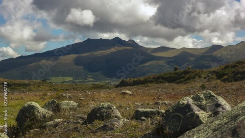 Pasochoa Volcano (4,200m) situated in the Ecuadorian Andes south of Quito, time-lapse. Viewed from the slopes of Cotopaxi. Lichen covered volcanic boulders in the foreground. photo