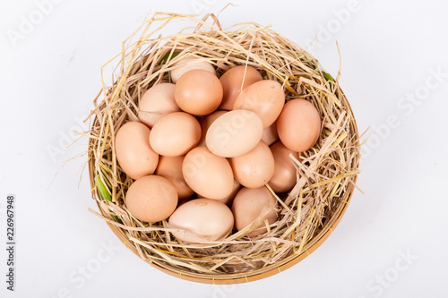 Hen or chicken eggs basket on the hey