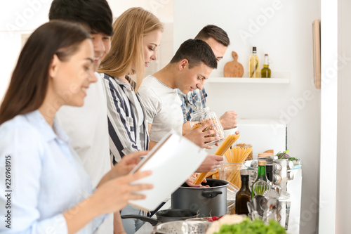 Friends cooking together in kitchen