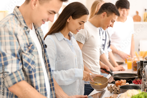 Friends cooking together in...