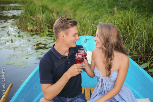 Cute young couple having romantic date in boat