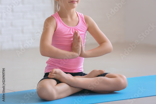 Little girl practicing yoga...