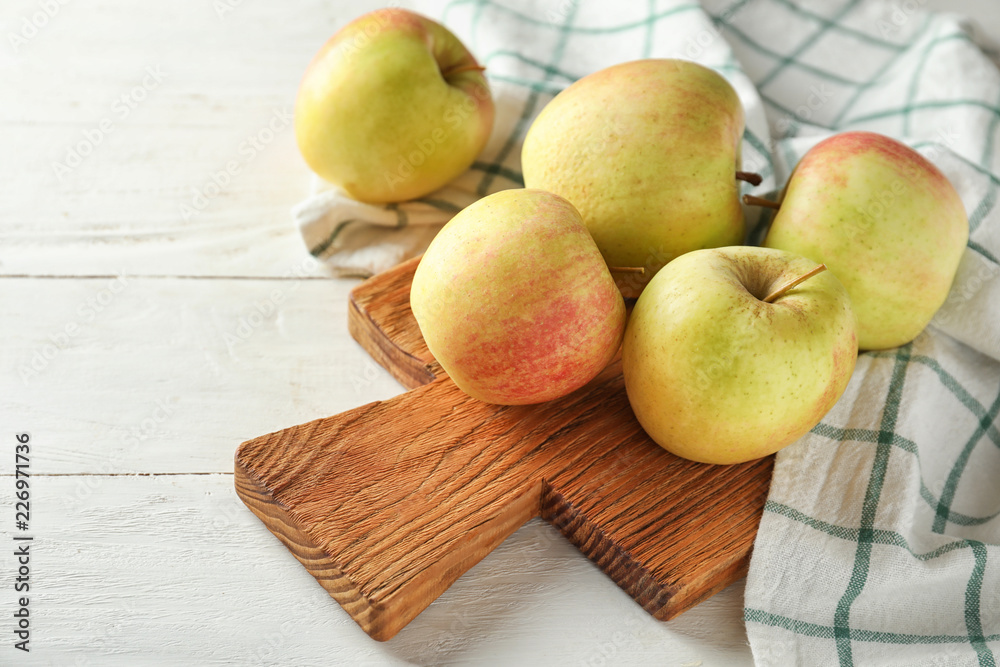 Ripe juicy apples on wooden board Ripe juicy apples on wooden board