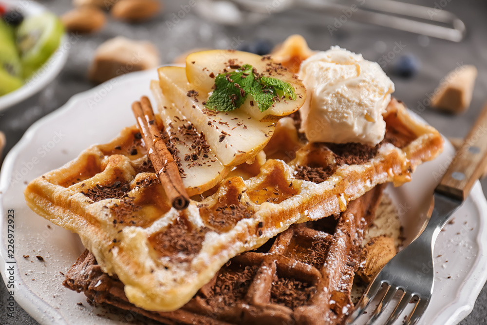 Delicious waffles with pear slices and ice cream on plate Delicious waffles with pear slices and ice cream on plate