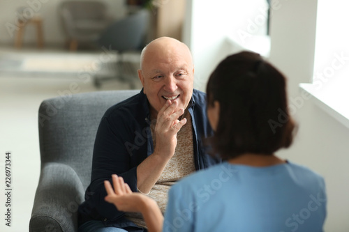 Принти на полотні Young nurse visiting elderly woman at home