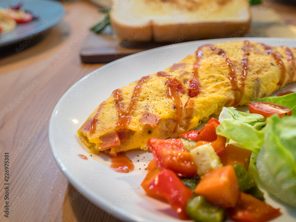 French Omelet with vegetable and salad, new menu design for healthy. Mix tomato, vegetable and seasoning when fried eggs. Fresh salad is compatible in same dish. A special meal for weight control. French Omelet with vegetable and salad, new menu design for healthy. Mix tomato, vegetable and seasoning when fried eggs. Fresh salad is compatible in same dish. A special meal for weight control.
