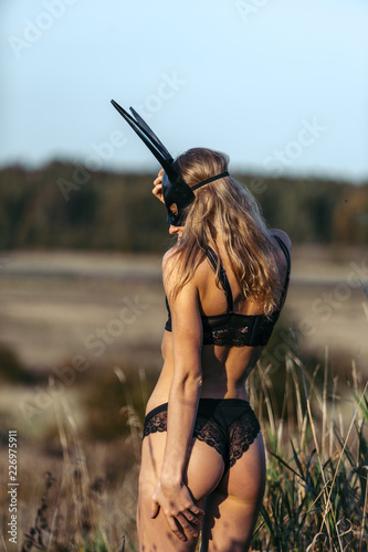 Beautiful sexy woman wearing black fashion bunny mask