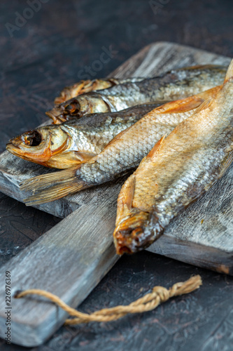 Dry salted fish on a wooden board.