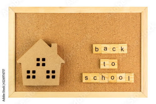 small model school and back to school word on cork board in wooden frame isolated on white background. photo