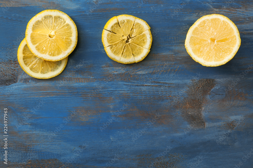 Slices of ripe lemon on color wooden background Slices of ripe lemon on color wooden background