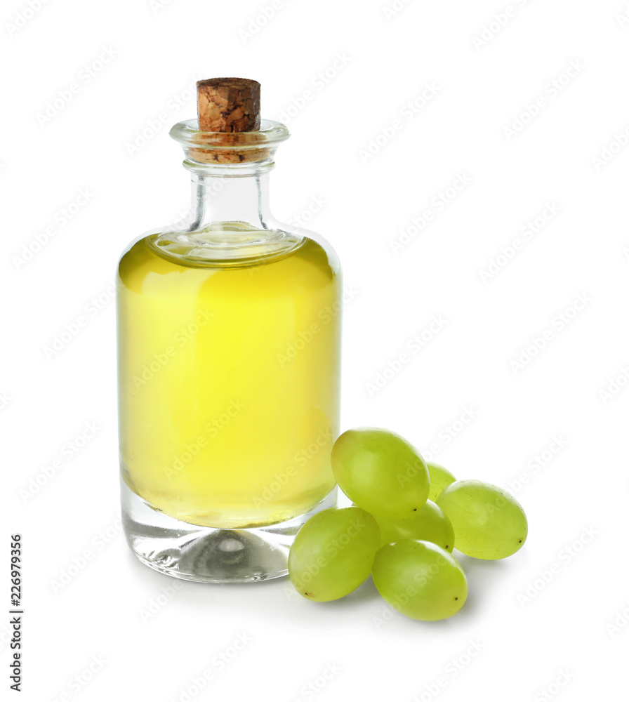 Bottle with grape seed oil on white background Bottle with grape seed oil on white background