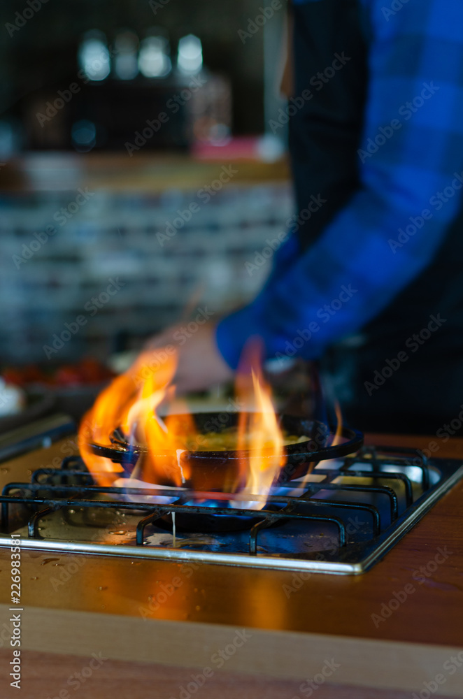 Chef is cooking eggs in butter for breakfast Chef is cooking eggs in butter for breakfast