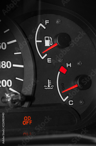Low fuel readings on car dashboard. Vertical photography