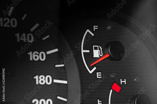 Low fuel readings on car dashboard. Horizontal photography