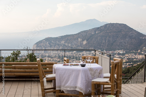 Prepared for supper table on the terrace overlooking the Bay of Naples and  Vesuvius. Sorrento. Italy