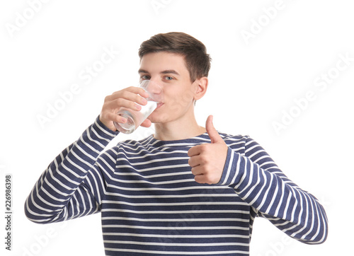 Young man drinking water on...
