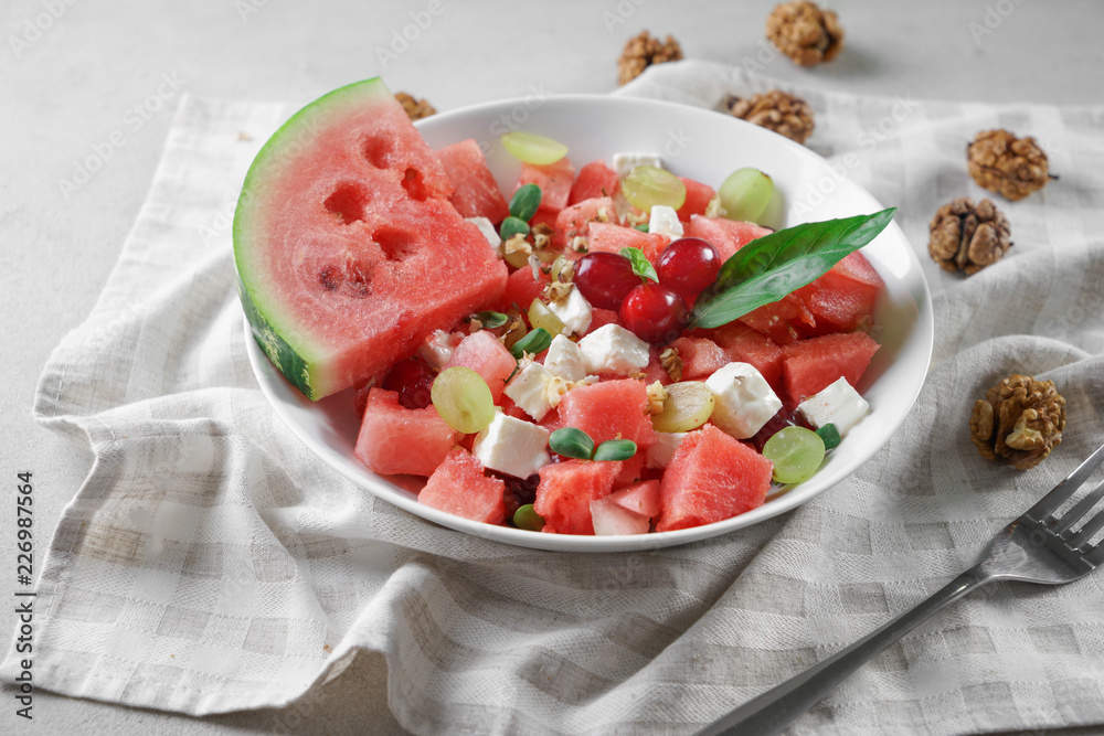 Plate with delicious watermelon salad on table Plate with delicious watermelon salad on table