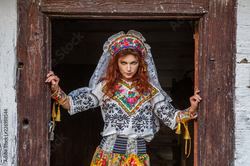 beautiful girl in a hut in national Slavic costume