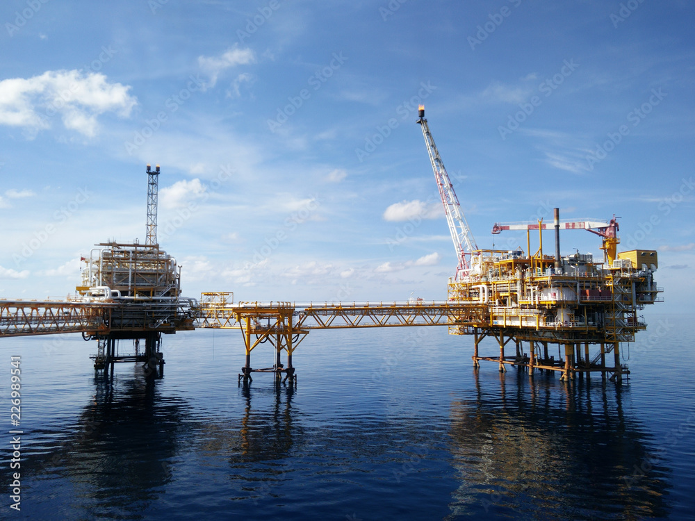 Oil and gas industry and hard work. Offshore construction platform for production oil and gas,Production platform and operation process by manual and auto function, oil and rig industry and operation.