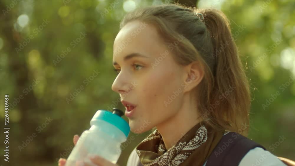 Close up portrait of Young beautiful woman drinking water Close up portrait of Young beautiful woman drinking water