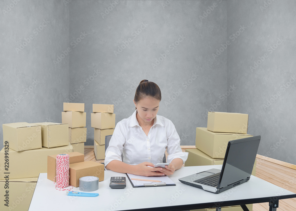 teenager owner business woman work at home with smartphone, laptop for online shopping writing the order. teenager owner business woman work at home with smartphone, laptop for online shopping writing the order.