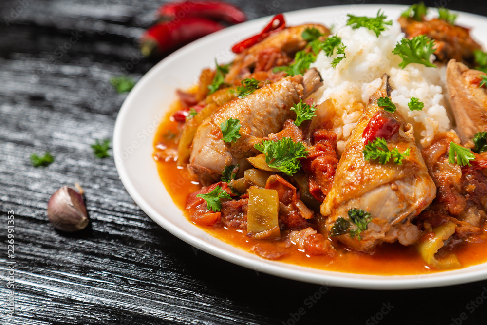 Chicken chilindron with thick vegetable sauce with red wine and dry-cured ham. Chicken chilindron with thick vegetable sauce with red wine and dry-cured ham.