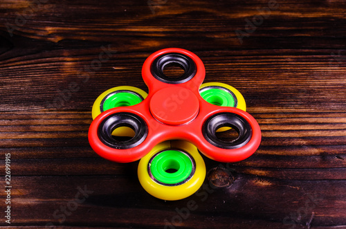 Two fidget spinners on wooden desk