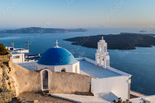 Fototapeta Naklejka Na Ścianę i Meble -  Iconic church with blue dome in Oia, Santorini island, Greece.