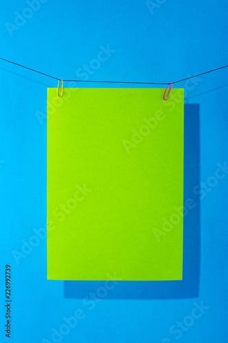 Green paper on a blue background for decoration, for text design, for a template
