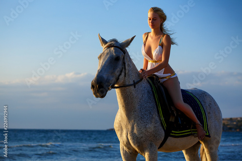 beautiful young woman in white dress by the sea with horse © Екатерина Переславце