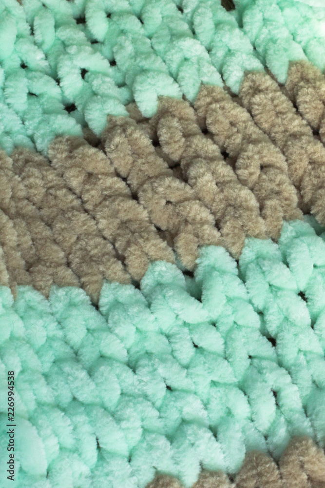 Knit. Woolen things. Bulky binding close-up. Hobbies for relaxing evenings. Knitted needlework. Knitted background. Wool thread. Soft yarn for baby clothes. Knit. Woolen things. Bulky binding close-up. Hobbies for relaxing evenings. Knitted needlework. Knitted background. Wool thread. Soft yarn for baby clothes.