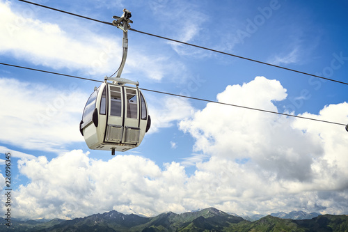 Cable car against cloudy blue sky