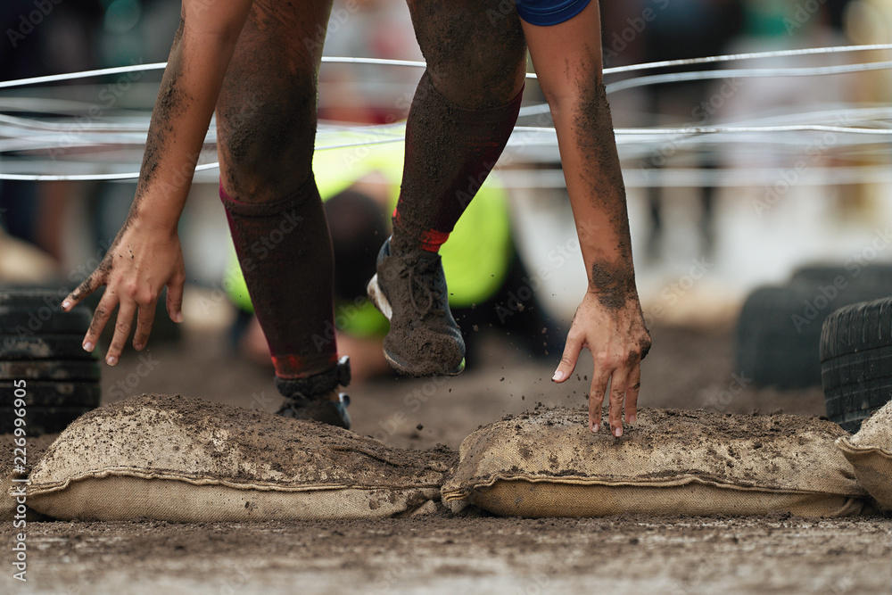 Crawling passing under a barbed wire obstacles obstacle course in the city