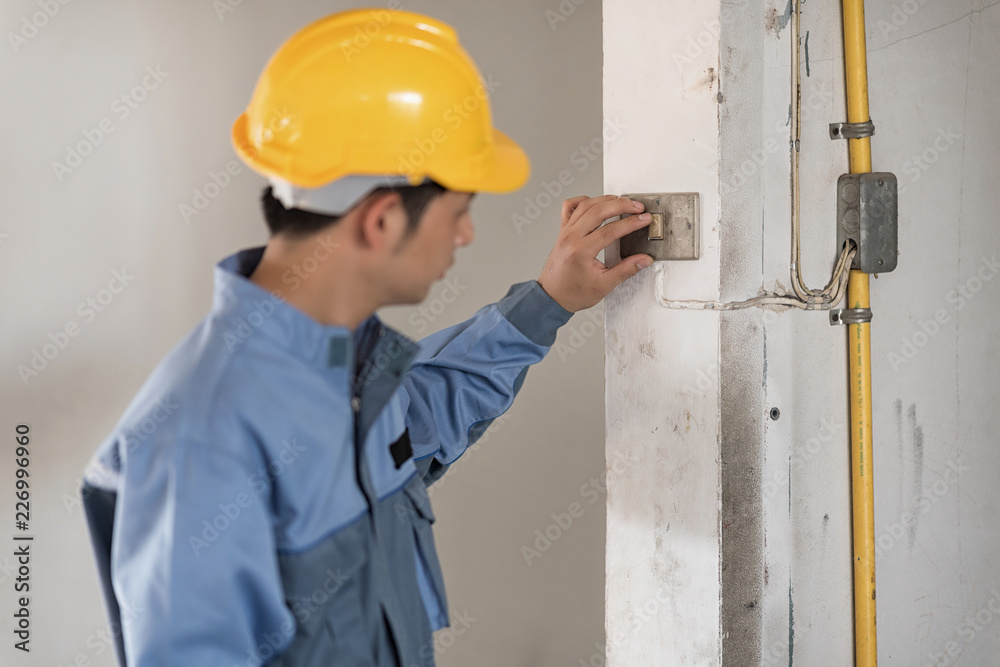 Technician man working with wearing yellow safety helmet. Technician man working with wearing yellow safety helmet.
