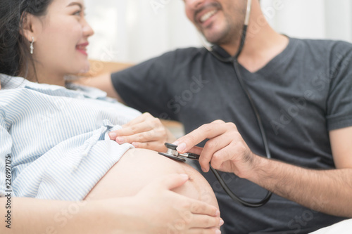 In Selective Focus Of Happy Family Checking New Baby In The Morning.Close Up Of A Beautiful Happy Pregnant Woman With Big Belly. Pregnancy And Motherhood Moment People And Expectation Concept.