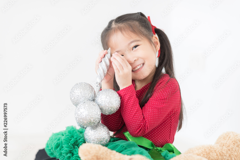 Happy Cute Asian Girl in Red and Green Colour in White room Background. Happy thanksgiving and Party Concept. Happy Cute Asian Girl in Red and Green Colour in White room Background. Happy thanksgiving and Party Concept.