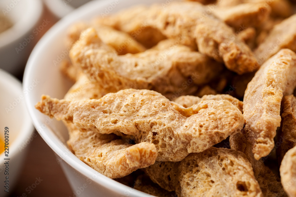 Raw dry soya meat chunks in a white bowl, macro shot Raw dry soya meat chunks in a white bowl, macro shot