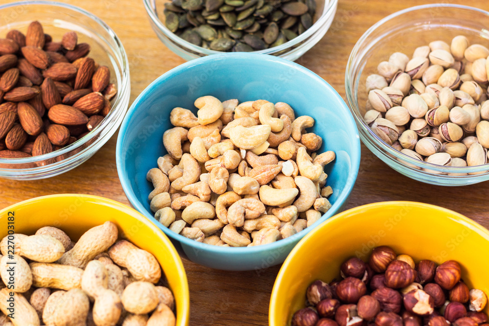 Assortment of mixed nuts on wood table background Assortment of mixed nuts on wood table background