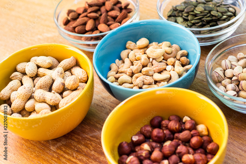 Assortment of mixed nuts on wood table background Assortment of mixed nuts on wood table background