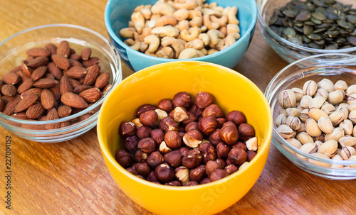 Assortment of mixed nuts on wood table background 