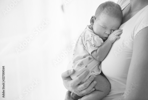 Newborn baby sleeping at mother breasts