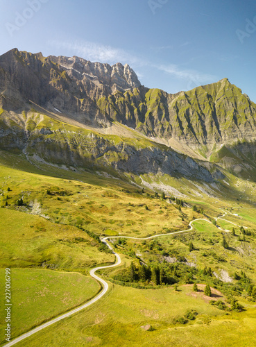 Road going toward a mountain in the french alps near the Col des Aravis.