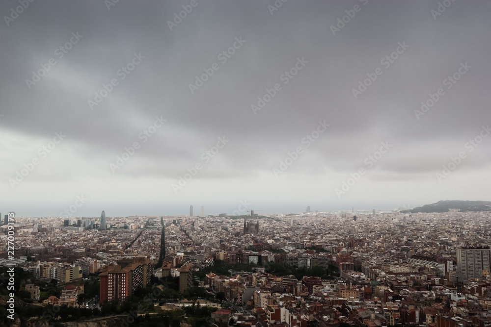 Fototapeta premium Cloudy view on Barcelona city from the mountain
