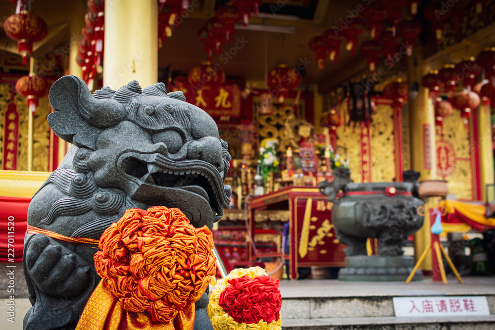 Chinese lion statue in Jiu Tean Geng Shrine, Phuket, Thailand.