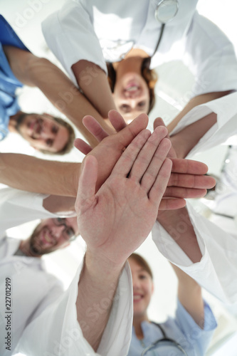 bottom view.a team of doctors at the medical center clasped their hands together