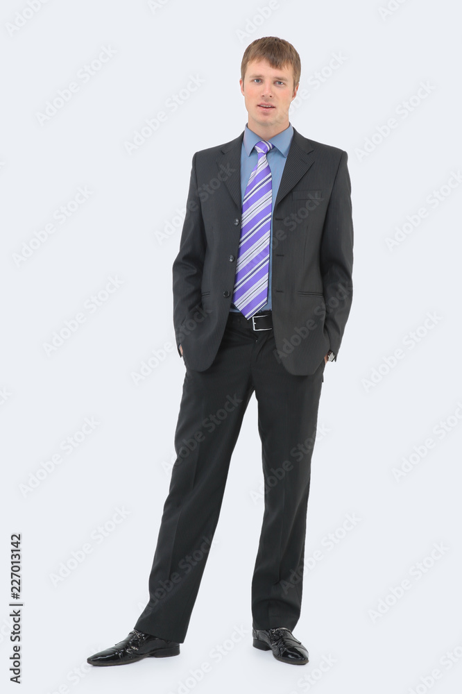 young businessman standing with hands in pockets isolated young businessman standing with hands in pockets isolated