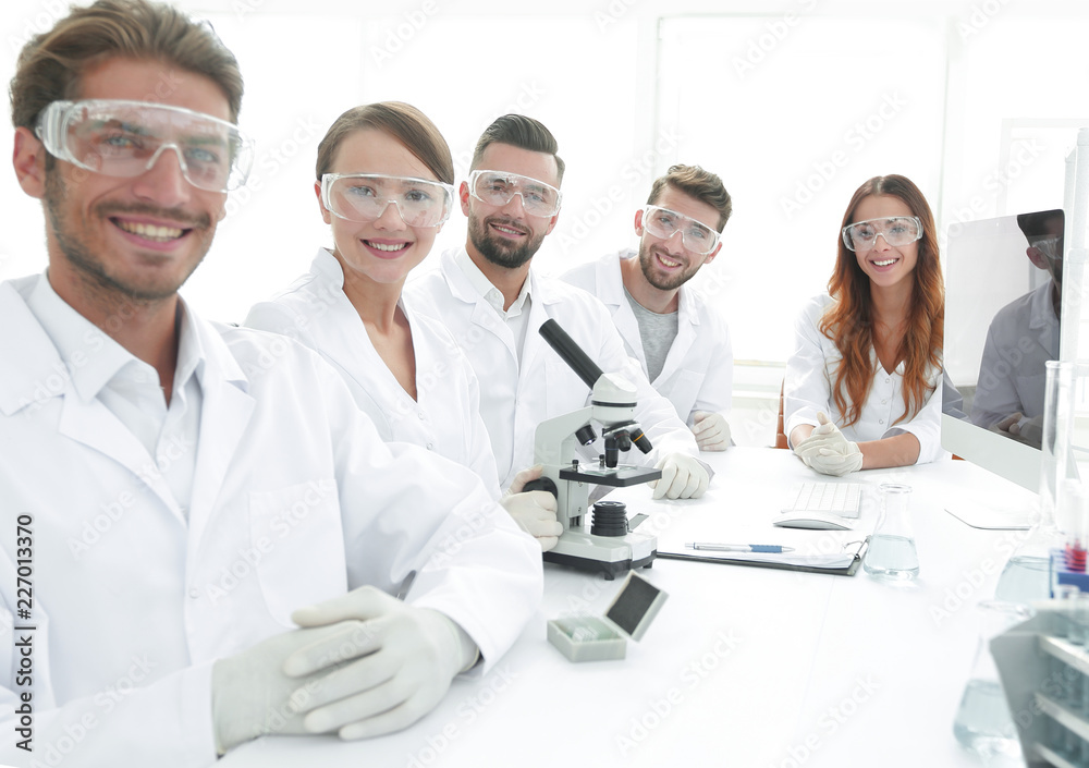 Male scientist and the team in the lab. Male scientist and the team in the lab.