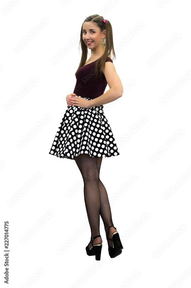 Young pin up girl in polka-dot dress, black stockings and in high heels  shoes isolated on the white background. Stock Photo | Adobe Stock