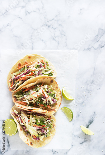 Obraz na płótnie Tacos with guacamole and coleslaw served with lime slices on a light background. w salonie